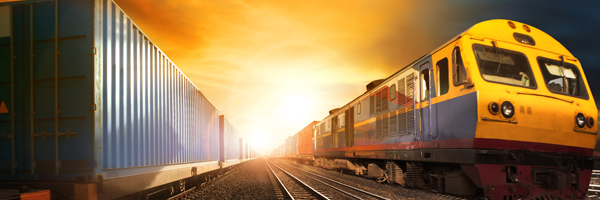 Rail transport company showing a fast moving train loaded with goods to deliver